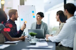 Team of employees smiling and being productive in a meeting room.