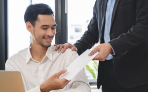 Portrait of a man receiving an envelope.